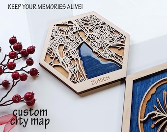 May include: A wooden hexagonal coaster with a laser-cut map of Zurich, Switzerland. The map is filled with blue resin and the city name is engraved below. The coaster is on a white surface.
