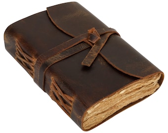 May include: A brown leather-bound journal with a rustic look. The journal has a leather strap closure and is tied with a knot. The pages are made of natural paper.