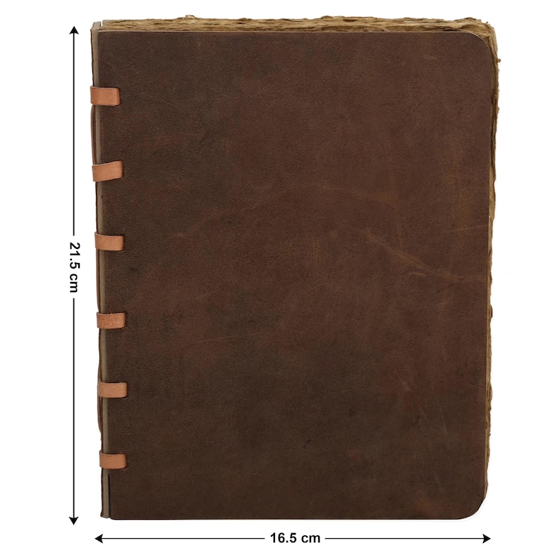 May include: A brown leather journal, measuring 21.5 cm x 16.5 cm, with a distressed, aged look. The cover is stitched with tan leather strips along the spine. The edges of the pages have a rough, uneven texture, enhancing the vintage feel.
