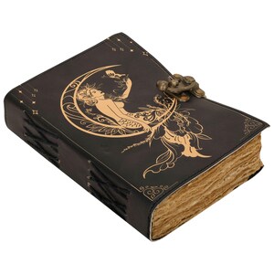 May include: Black leather journal with a gold embossed design of a mermaid sitting on a crescent moon. The journal has a clasp closure and is bound with black thread.