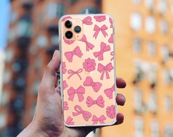 May include: A clear phone case with a pink and white design featuring multiple pink bows. The case is designed for an iPhone.