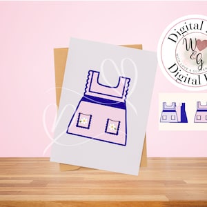 May include: A pink digital file print of a dress with a blue outline, featuring two square pockets with daisy designs. The image is on a white card, propped up by a brown card, with a pink background and a wooden surface.