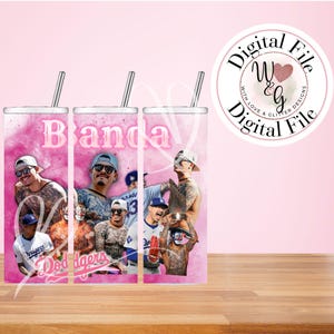 May include: Three stainless steel tumblers with a pink watercolor background and images of men. The word "Banda" is printed on the tumblers. The tumblers have a silver straw and the text "Dodgers" is visible.