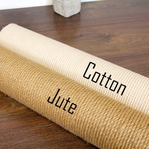 May include: Two rolls of rope for cat scratching posts, one is natural jute and the other is white cotton. The jute roll is labelled "Jute" and the cotton roll is labelled "Cotton".
