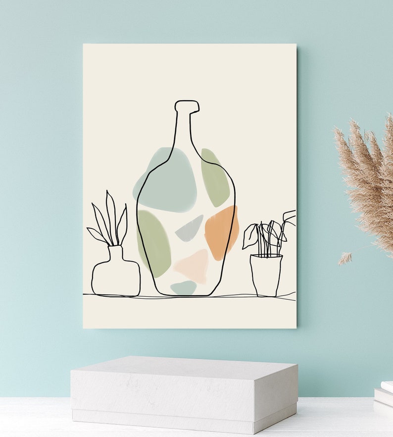 May include: Abstract art print with a black line drawing of a vase and colourful shapes in green, blue, and orange. Two additional line drawings of plants in pots are also included. The background is a light beige colour.
