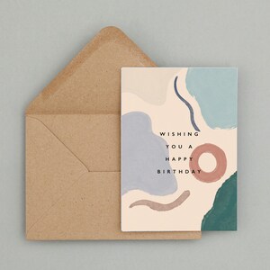 May include: A birthday card featuring abstract shapes in blue, teal, and brown, with the message "Wishing You a Happy Birthday." The card is accompanied by a brown envelope, ideal for sending birthday greetings.