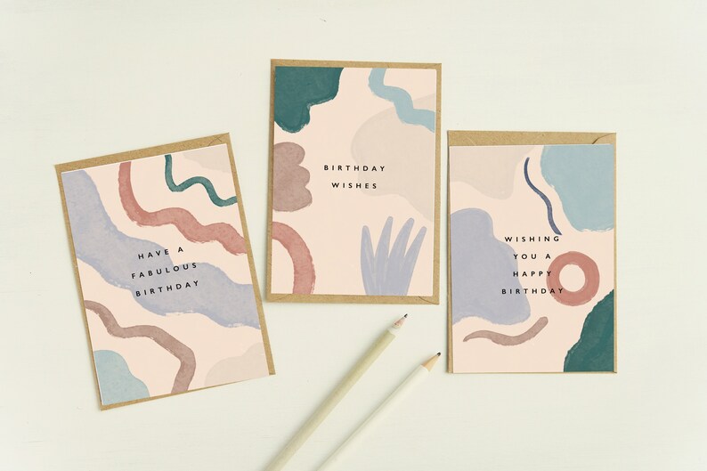 May include: Three birthday cards with abstract watercolour designs in pink, blue, and green. Each card has a kraft paper border and a different birthday message: "Have a Fabulous Birthday," "Birthday Wishes," and "Wishing You a Happy Birthday."