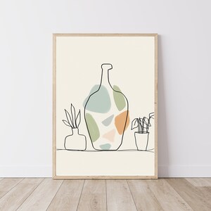 May include: A framed art print with a minimalist line drawing of a bottle with abstract shapes in green, blue, and orange. Two small potted plants and a vase are also depicted in the artwork. The background is a light beige colour.