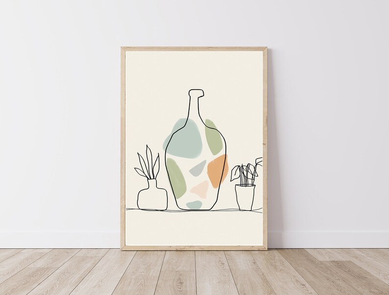 May include: A framed art print with a minimalist line drawing of a bottle with abstract shapes in green, blue, and orange. Two small potted plants and a vase are also depicted in the artwork. The background is a light beige colour.