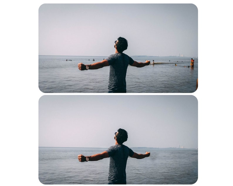 May include: A person stands with arms outstretched on a beach, facing the ocean. The water is calm and the sky is clear.