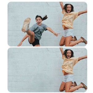 May include: Two people are jumping in the air in front of a white brick wall. The person on the left is wearing a grey shirt, black shorts, and white sneakers. The person on the right is wearing a yellow shirt, white shorts, and brown sandals.