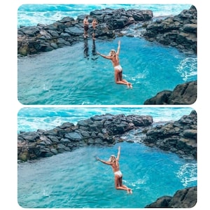 May include: Two people jump into a natural pool of clear blue water surrounded by dark gray rocks.