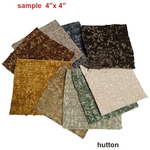 May include: A collection of fabric swatches, each measuring 4" x 4", in various colors including brown, gold, green, and gray. The swatches have a textured appearance. The word "sample" and the brand name "hutton" are visible.