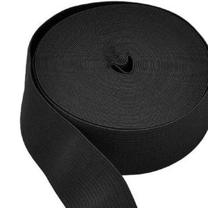 May include: A roll of black elastic band, a type of fabric used for sewing and crafts.
