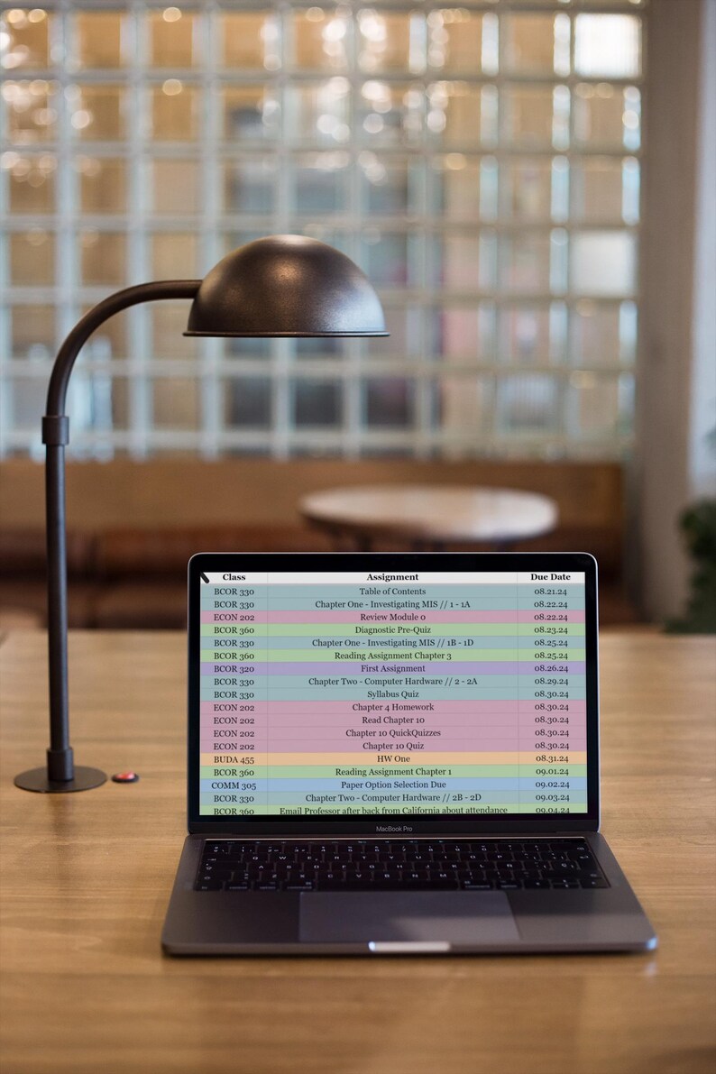 May include: A laptop computer screen displaying a class schedule with course names, assignment titles, and due dates. The schedule includes courses like BOOR 130, BOOR 330, ECON 200, and BOOR 360. The assignments include topics like "Investigating MIS", "Computer Hardware", and "Syllabus Quiz". The due dates are listed in the format MM.DD.YY.