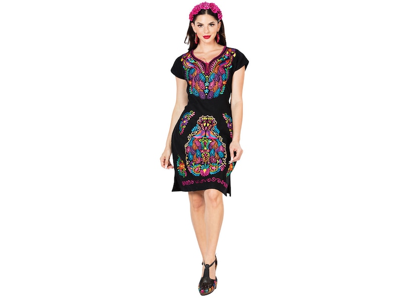 May include: A black short-sleeved dress with colorful embroidery. The dress has a V-neck and a floral pattern. The model is wearing a pink flower crown.