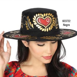 May include: A black felt hat with gold and red painted hearts and floral designs. The hat has a wide brim and a flat crown. The text "603722 Negro" is visible on the right side of the image.