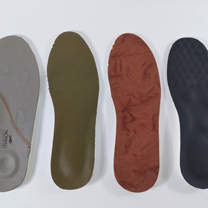 May include: Four different insoles for shoes. The insoles are made of different materials, including leather, suede, and foam. The insoles are all in the same shape and size. The insoles are all in different colors, including gray, green, brown, and black.