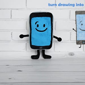 May include: A blue plush toy shaped like a smartphone with a smiling face. The toy has black arms and legs. The text "turn drawing into a plush" is visible above the toy.