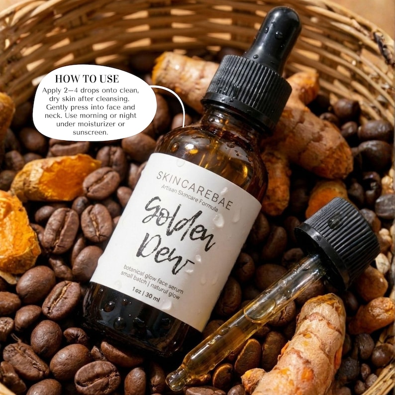 May include: A brown glass bottle of "Golden Dew" botanical glow face serum with a black dropper. The label reads "SKINCAREBAE Artisan Skincare Formula". The bottle is surrounded by coffee beans and turmeric.