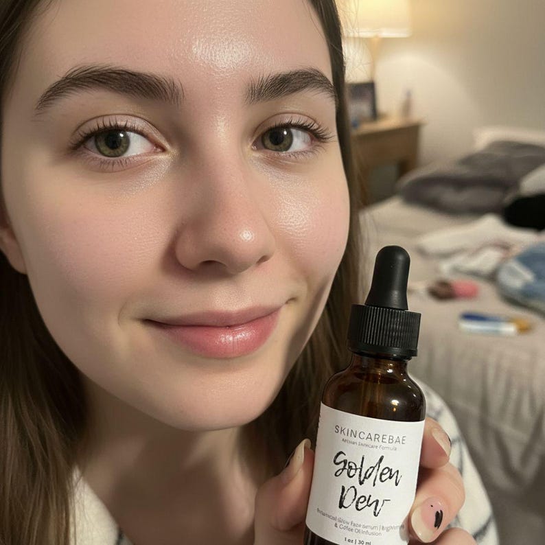 May include: A brown glass bottle with a black dropper, labeled "SKINCAREBAE Golden Dew." The label also mentions a botanical glow face serum and collagen infusion. The bottle is held in front of a person.