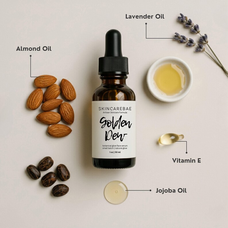 May include: A skincare product display featuring a brown glass bottle labeled "Golden Dew" with a dropper, surrounded by almonds, jojoba oil, lavender, and vitamin E. The product is a botanical glow face serum.