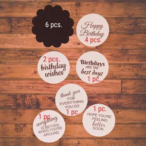 Puede incluir: Un conjunto de 16 pegatinas redondas con varios saludos y mensajes de cumplea&ntilde;os. Las pegatinas est&aacute;n impresas en papel blanco con texto rojo. Las pegatinas incluyen mensajes como "Feliz cumplea&ntilde;os", "2 pcs. deseos de cumplea&ntilde;os", "Los cumplea&ntilde;os son los mejores d&iacute;as", "Gracias por todo lo que haces", "1 pc. todo es mejor cuando est&aacute;s cerca", y "Espero que te sientas mejor pronto".