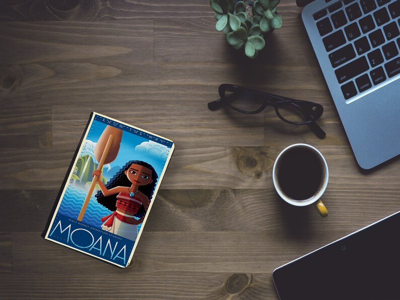 May include: A book cover featuring a cartoon illustration of a Polynesian woman with brown hair and a red and white outfit holding a wooden paddle. The book cover is blue and white with the text "Moana" in large blue letters and the text "Finding the Way" in smaller white letters.