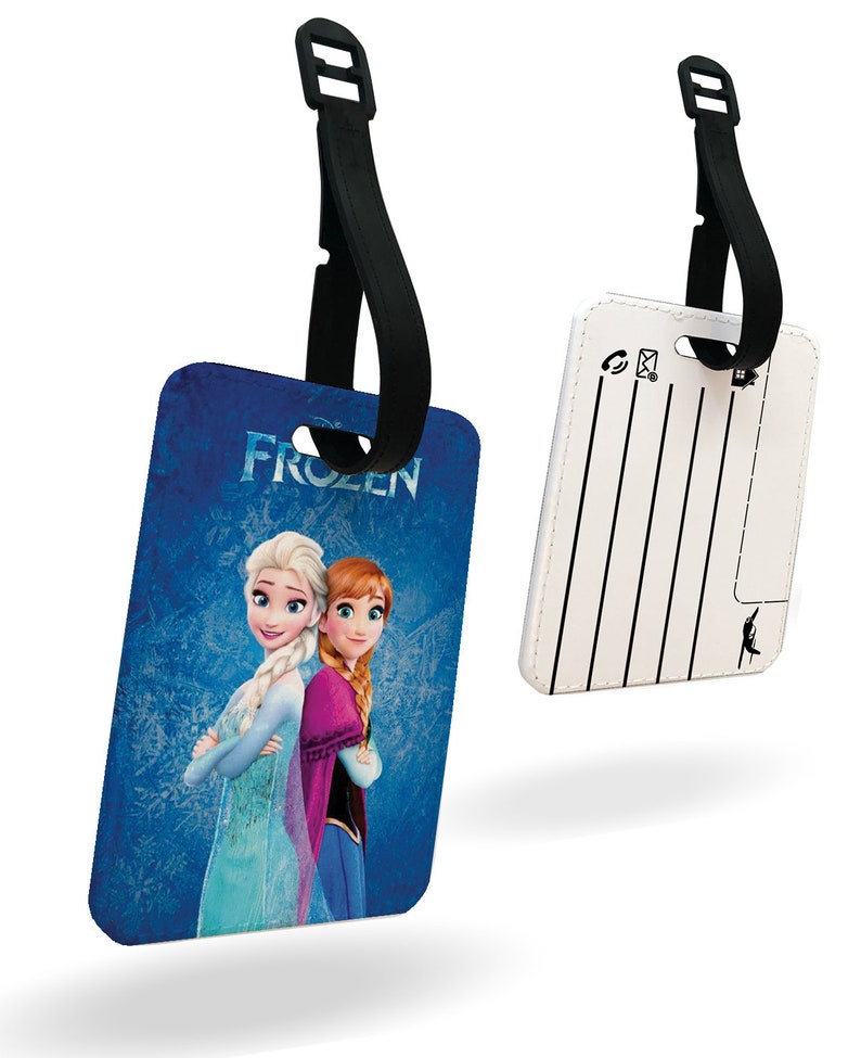 May include: A blue and white luggage tag featuring Elsa and Anna from the film Frozen. The tag has a black strap and a white writing area on the reverse.