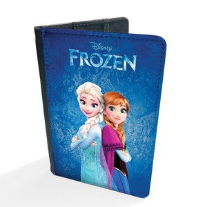 May include: A blue passport holder with a Disney Frozen design featuring Elsa and Anna. The text "Disney Frozen" is printed in white on the front.
