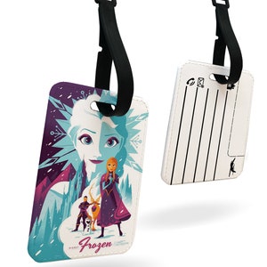 May include: White luggage tag with a colorful illustration of characters from the Disney movie Frozen. The tag has a black strap and a blank space for writing contact information. The text "Frozen" is printed on the tag.