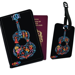 May include: Black passport holder and luggage tag featuring a colorful guitar design with characters from the Disney Pixar movie Coco. The guitar is outlined in blue and filled with floral patterns and characters. The text "Disney Pixar COCO" is at the bottom of the holder.
