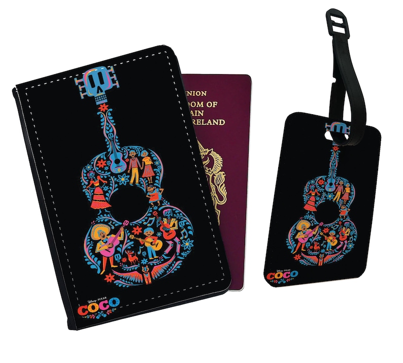 May include: Black passport holder and luggage tag featuring a colorful guitar design with characters from the Disney Pixar movie Coco. The guitar is outlined in blue and filled with floral patterns and characters. The text "Disney Pixar COCO" is at the bottom of the holder.