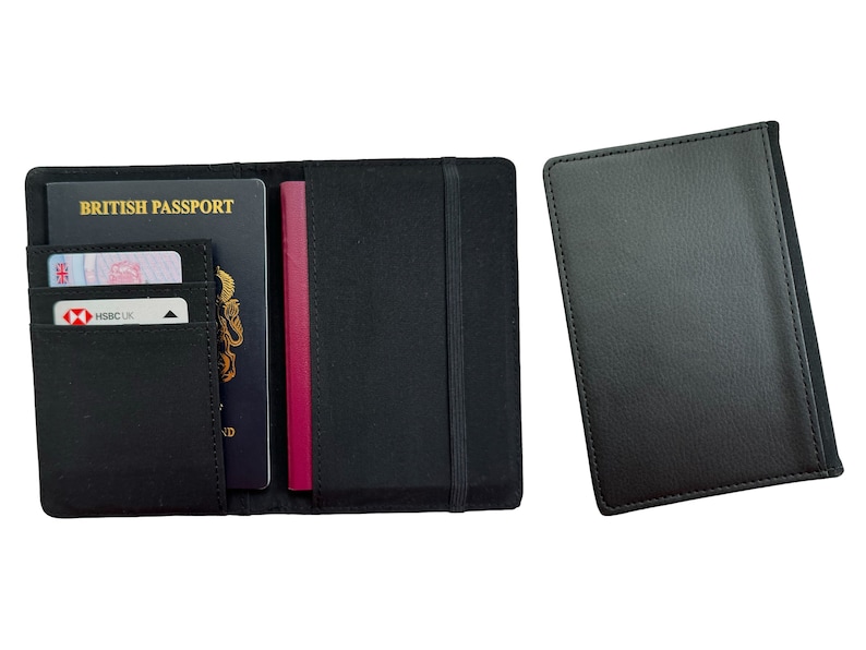 May include: Black leather passport holder with a built-in elastic strap and a separate pocket for cards. The holder is open to show a British passport, a credit card, and a burgundy passport.
