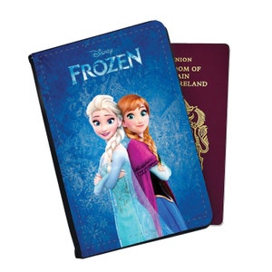 May include: A blue passport holder with a Frozen design featuring Elsa and Anna from the Disney movie. The text "Disney Frozen" is printed on the front.