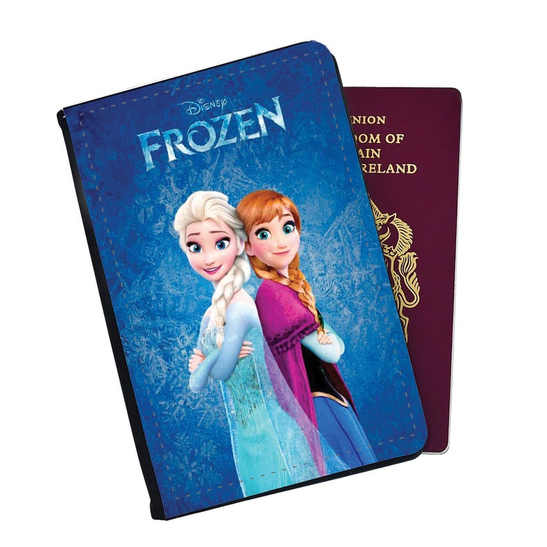 May include: A blue passport holder with a Frozen design featuring Elsa and Anna from the Disney movie. The text "Disney Frozen" is printed on the front.