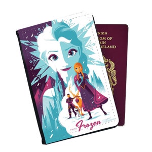 May include: A passport holder featuring a colorful illustration of Elsa and Anna from the Disney movie Frozen. The image includes a castle, snowflakes, and the text "Frozen".