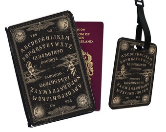 Könnte beinhalten: Ein schwarzer Reisepasshalter und ein Gepäckanhänger im Ouija-Brett-Design sowie ein Reisepass. Der Passhalter und der Anhänger zeigen das Alphabet, Zahlen und das Wort "Goodbye". Das Design umfasst Illustrationen von Monden, Händen und anderen okkulten Symbolen.