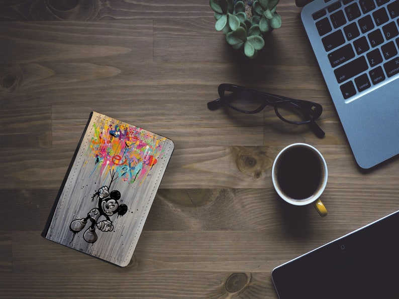 May include: A colourful, abstract design with Mickey Mouse holding onto a bunch of balloons. The design is on a grey, textured background.