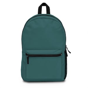 May include: Teal backpack with a black zipper, handle, and mesh side pocket. The backpack has a front pocket with a black zipper. The bag is a solid teal color.