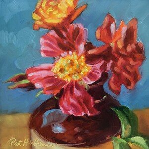 May include: An oil painting depicting a bouquet of vibrant red and orange flowers with yellow centers in a dark brown vase. The background is a solid blue, and the artist's signature, Pat Huffman, is visible in the bottom left corner of the canvas.