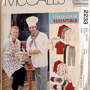 May include: McCall's 2233 sewing pattern envelope for Uniform Essentials, featuring illustrations of chef jackets, pants, aprons, and hats. The cover displays a photograph of two individuals wearing a chef hat, white jacket, and patterned apron.