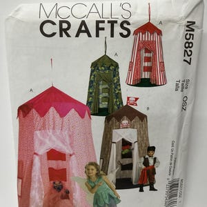 May include: McCall's Crafts M5827 sewing pattern envelope featuring illustrations of three hanging play tents: a pink patterned tent, a green camouflage tent, and a brown pirate-themed tent with a skull and crossbones flag.