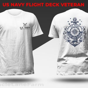 May include: White t-shirt with a US Navy Flight Deck Veteran design. The front features the US Navy logo and text. The back displays a detailed navy-themed graphic with an anchor, compass, and text. The shirt is a classic crew neck style.