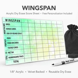 May include: A rectangular acrylic dry erase score sheet for the game Wingspan, featuring a green and yellow watercolor background with black grid lines and text. Includes a black velvet drawstring bag, a black eraser, and a white dry erase marker.
