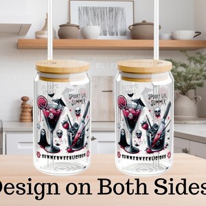 May include: Two glass tumblers with bamboo lids and straws. Each tumbler features a spooky cocktail design with skulls, a cocktail, and the text "SPOOKY GIRL SUMMER" and "SUMMERWEENLICIOUS". The design is on both sides.