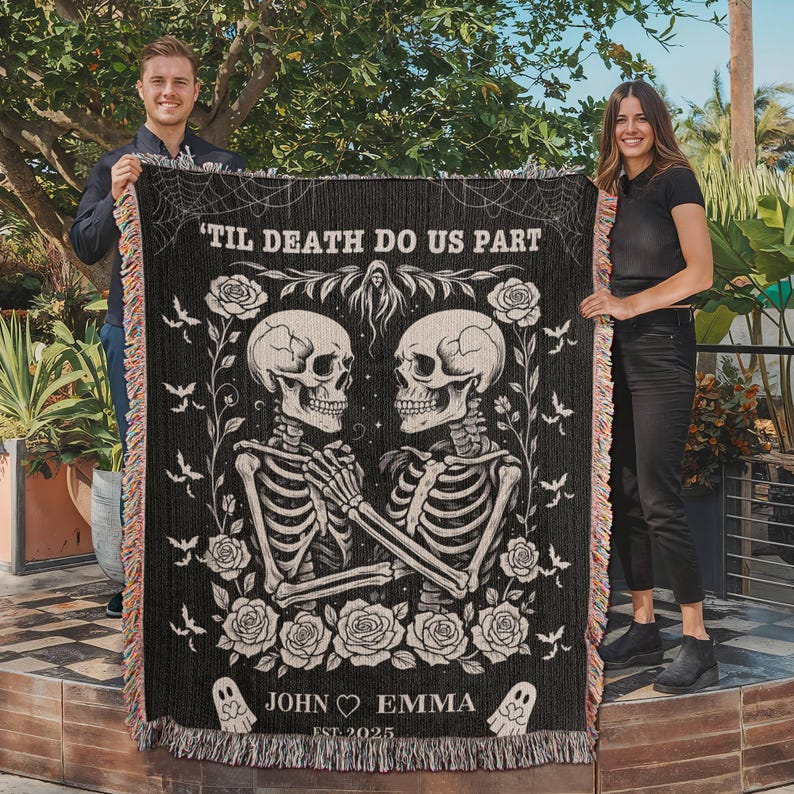 May include: Black woven blanket with a gothic design featuring two skeletons holding hands, surrounded by roses and bats. The text "'Til Death Do Us Part" is at the top, with "John & Emma Est. 2025" at the bottom. The blanket has a fringed edge.