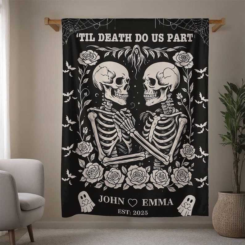 May include: Black blanket with a white skeleton couple design, surrounded by roses and bats. Text reads "'TIL DEATH DO US PART," with names "JOHN & EMMA" and the year "EST. 2025." Decorative, gothic-themed home decor.