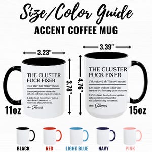 May include: Two white coffee mugs with black rims, one 11oz and one 15oz, with the text "The Cluster Fuck Fixer" and a definition. The mugs are shown with different colored rims: black, red, light blue, navy, and pink.