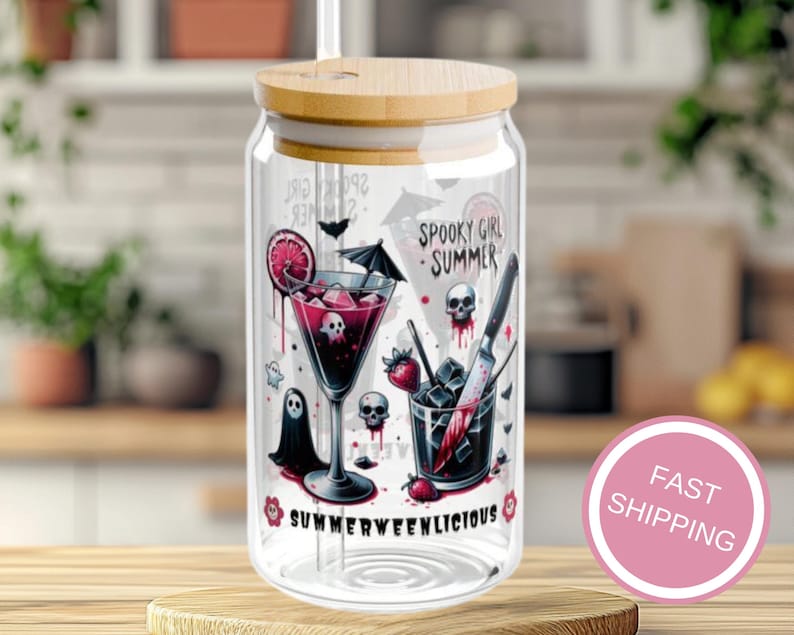 May include: A clear glass beverage can with a bamboo lid, featuring a spooky summer design. The design includes a cocktail with skull ice cubes, a ghost, and the text "Spooky Girl Summer" and "Summerweenlicious".